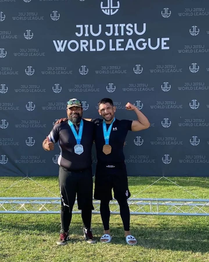 Two Ventura Fight & Fitness competitors with medals at a Jiu Jitsu World League event